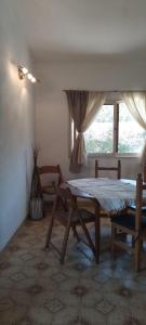 a dining room with a table and a window at Casa/ Villa General Belgrano in Villa General Belgrano