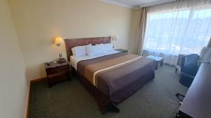 Ένα ή περισσότερα κρεβάτια σε δωμάτιο στο Hotel Diego de Almagro Temuco