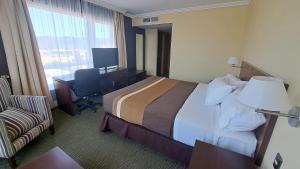 Ένα ή περισσότερα κρεβάτια σε δωμάτιο στο Hotel Diego de Almagro Temuco