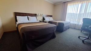 Ένα ή περισσότερα κρεβάτια σε δωμάτιο στο Hotel Diego de Almagro Temuco