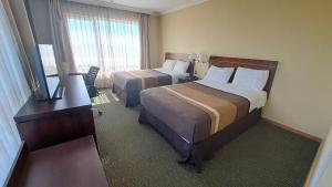 Ένα ή περισσότερα κρεβάτια σε δωμάτιο στο Hotel Diego de Almagro Temuco