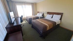 Ένα ή περισσότερα κρεβάτια σε δωμάτιο στο Hotel Diego de Almagro Temuco