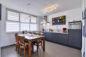 a kitchen with a wooden table and some chairs at Studio Apartment Harbour Pula in Pula