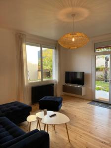 a living room with a couch and a table at Maison rouge in Millau