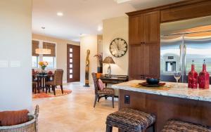 a kitchen and living room with a clock on the wall at Mauna Lani Kamilo Home 424 in Waikoloa