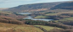 an aerial view of a valley with two reservoirs at The Bungalow in Longdendale