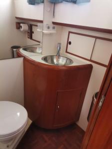 a bathroom with a sink and a toilet at Bateau Atypique Yacht La Rochelle in La Rochelle