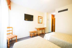 Postel nebo postele na pokoji v ubytování Hotel La Colina