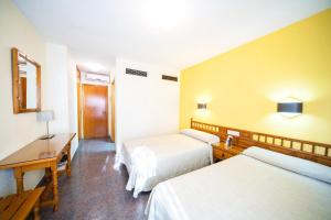 Postel nebo postele na pokoji v ubytování Hotel La Colina