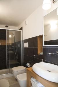 a bathroom with a sink and a toilet and a shower at B&B La Palma in Santa Marina Salina