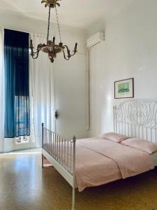 a bedroom with a bed and a chandelier at MY HOUSE to Cinque terre in La Spezia