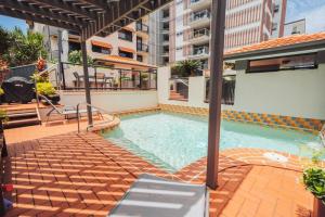 a swimming pool on the side of a building at Waterfront Apt Maroochy River in Maroochydore