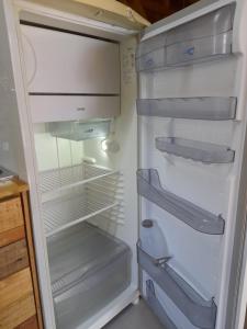 an empty refrigerator with its door open in a kitchen at Sobrado Rustico iguacu in Foz do Iguaçu