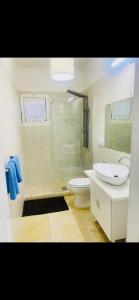 a bathroom with a shower and a toilet and a sink at Dimora al Mare in Villanova di Ostuni
