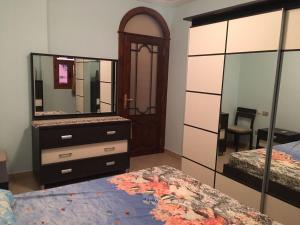 1 dormitorio con 2 camas, tocador y espejo en Villa Dina en Sharm El Sheikh