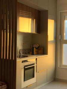 a kitchen with a white stove top oven next to a window at Mali Raj Makarska in Makarska +16 photos