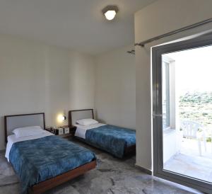 Posteľ alebo postele v izbe v ubytovaní Rodon Hotel