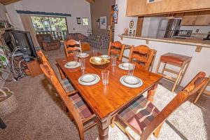 a wooden table and chairs in a living room at 3407 Pine Hill Home in South Lake Tahoe