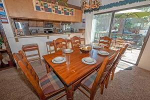 a dining room with a wooden table and chairs at 3407 Pine Hill Home in South Lake Tahoe