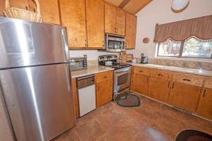 a kitchen with a stainless steel refrigerator and wooden cabinets at 3407 Pine Hill Home in South Lake Tahoe +11 photos