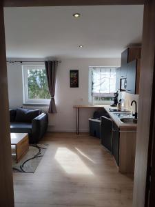 a kitchen and living room with a couch and a table at Kutscherhaus in Nagel