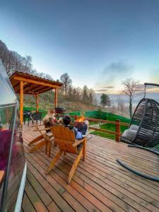 a group of people sitting on a wooden deck at ME-GA Glamping in Sapanca