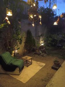 a patio with a chair and a table and lights at Casa rústica in Oaxaca City