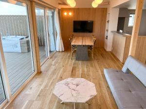 a living room with a table and a couch at Beach SPA TSUDA 2&3 - Vacation STAY 76782v in Sanuki