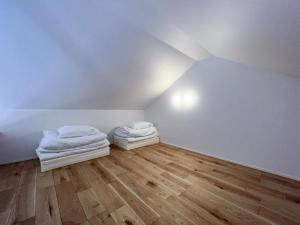 a attic room with two white towels on a wooden floor at Beach SPA TSUDA 2&3 - Vacation STAY 76782v in Sanuki