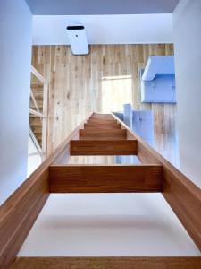 a room with wooden stairs and blue chairs at Beach SPA TSUDA 2&3 - Vacation STAY 76782v in Sanuki