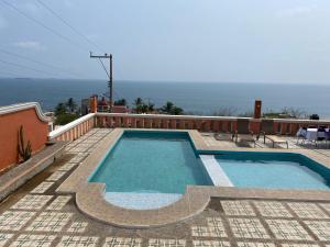 uma piscina em cima de uma casa com o oceano em Casa vista mar em Salina Cruz