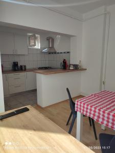 eine Küche mit einem Tisch und einer Arbeitsplatte in der Unterkunft Horea 11 in Sighişoara