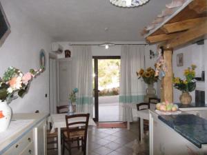 a kitchen with a table and chairs and a dining room at Bed & Breakfast Mare Isole in La Maddalena