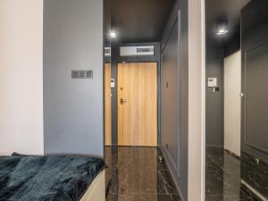 a hallway with a door and a room with a bed at Enes Apartments Softy Lofty 2 in Wrocław