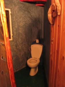 a bathroom with a toilet in a small room at Riad Les 5 Lunes in Aït Idaïr