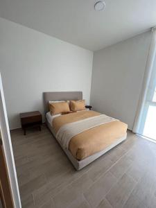 a bedroom with a bed in a white room at Departamento Tipo Loft, zona ajijic. in Jocotepec