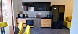 a kitchen with a stove and a refrigerator and a table at Penzion Ivka in Skalica +26 photos