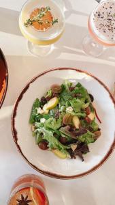 a salad on a plate on a table with glasses at W San Francisco in San Francisco