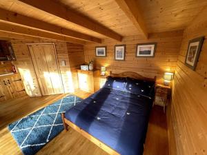 a bedroom with a bed in a wooden cabin at The Bee Hive Garden Room in Dorchester