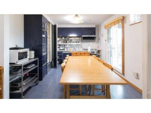 a kitchen with a long wooden table and chairs at TEA TREES - Vacation STAY 86519v in Tateyama