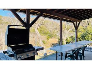 a grill and picnic tables in a pavilion at TEA TREES - Vacation STAY 86519v in Tateyama