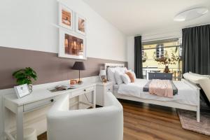 een witte slaapkamer met een bed en een bureau bij Leonardo50 Apartment in Boedapest