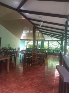 a dining room with wooden tables and chairs at House Susan in San Pedrillo
