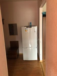 a white refrigerator in the corner of a room at Maleva apartaments in Kohtla-Järve