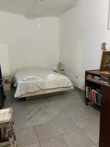 a bedroom with a bed and a dresser in it at Luminoso departamento en Planta Alta in Formosa