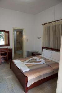Postel nebo postele na pokoji v ubytování Hotel Glaros