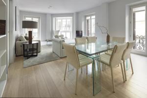 Easo Suite 7 by FeelFree Rentals في سان سيباستيان: غرفة طعام مع طاولة وكراسي زجاجية