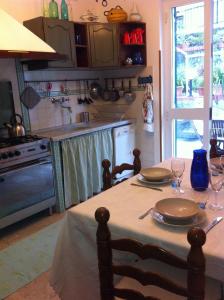 a kitchen with a table with plates on it at Ca D'Ancioa in Moneglia