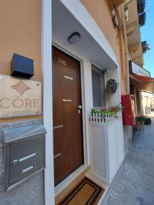 a door to a store with a sign on it at Core Cagliari in Cagliari