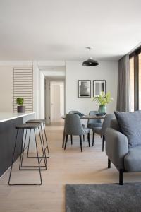 a living room with a table and chairs at Neighbourgood Old Cape Quarter in Cape Town